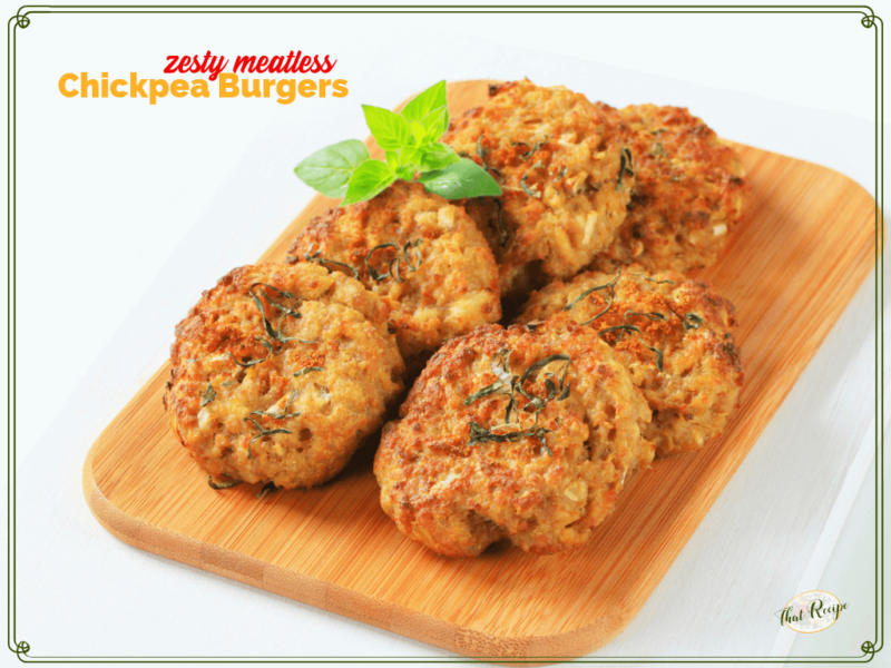 garbanzo bean burger patties on a wooden board with text overlay "Zesty meatless chickpea burgers"