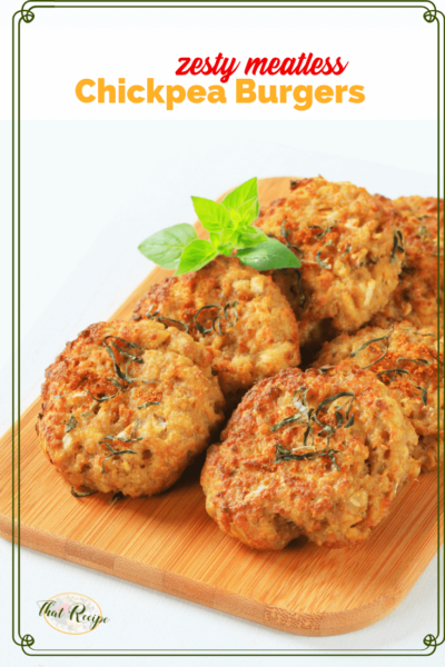 garbanzo bean burger patties on a wooden board with text overlay "Zesty meatless chickpea burgers"