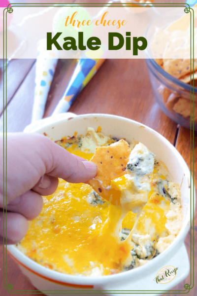 cheesy kale dip and chips on a table with party favors