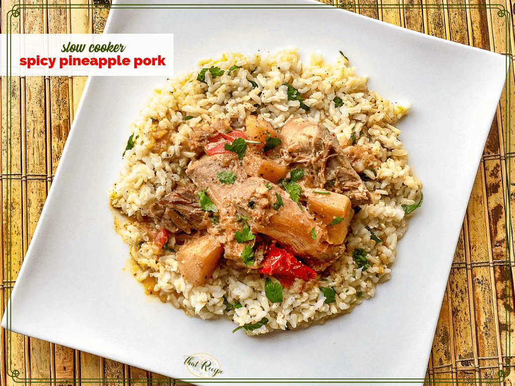 Rice topped with spicy pineapple pork on a square plate