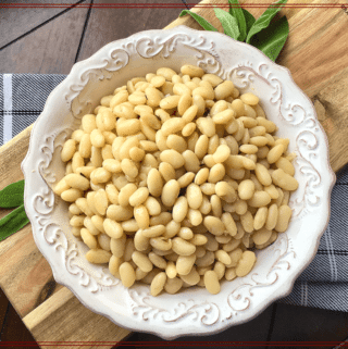 white beans in a bowl with fresh sage