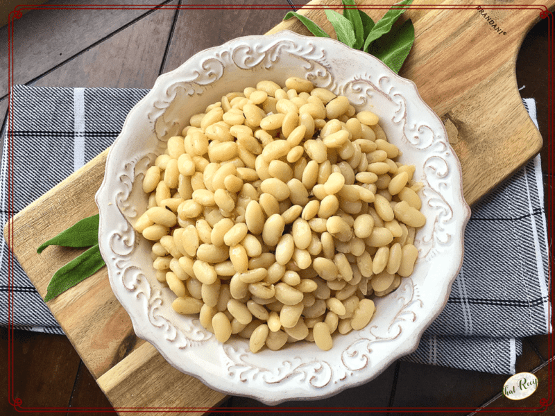 white beans in a bowl with fresh sage